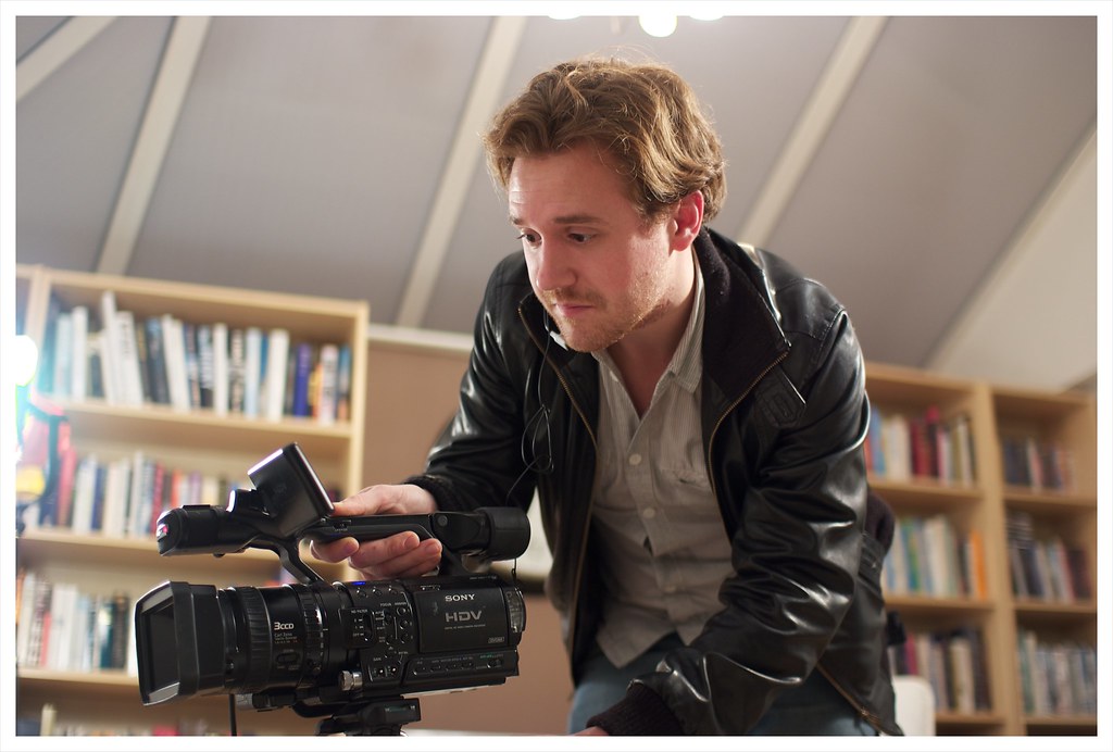 Camera operator setting up the video camera