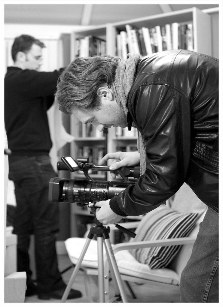 Camera operator setting up the video camera