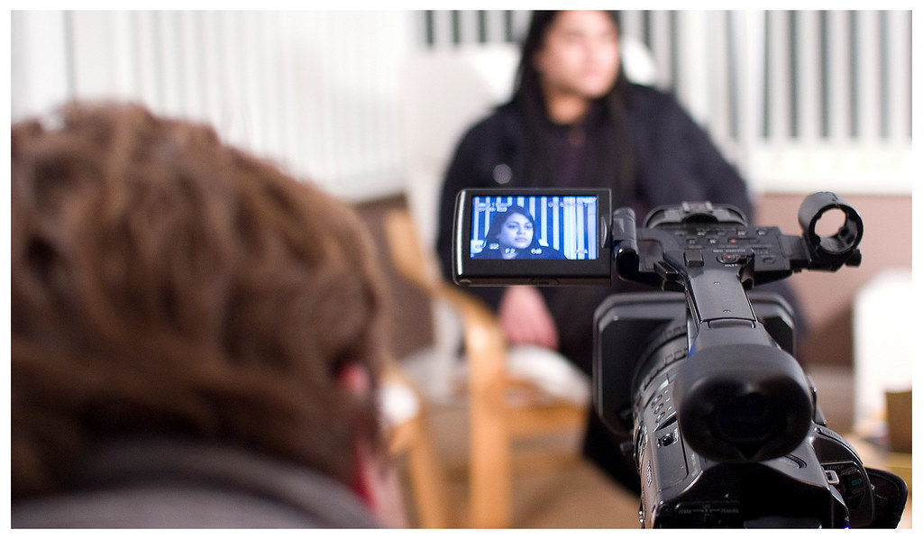Camera operator setting up the video camera